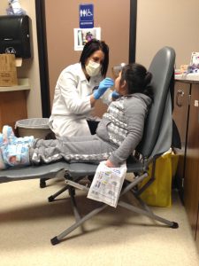 The Greenvale Park Dental Clinic featuring a dentist working on a young girl's teeth.